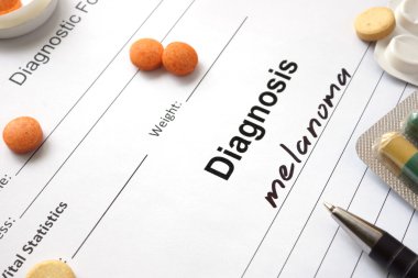 Tanılama formu ve hapları ile yazılmış tanı Melanom.