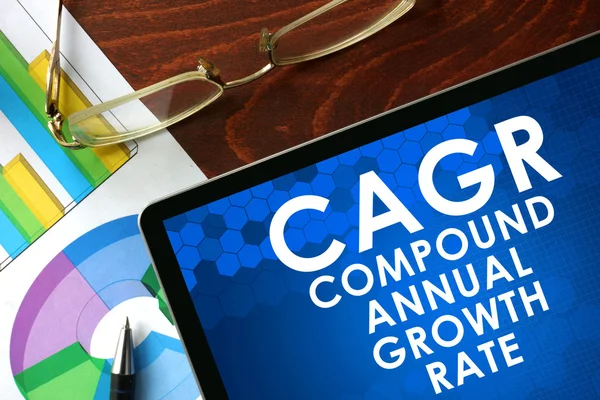 Tablet with compound annual growth rate (CAGR) on a table. — Stock Photo, Image