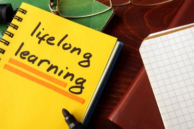 Notebook with  lifelong learning sign. clipart