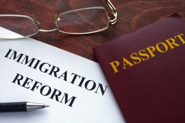 Paper with immigration reform on a table. clipart