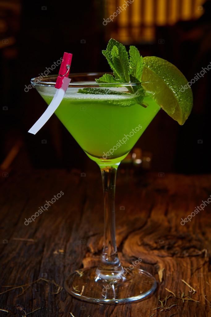 Martini glass with green cocktail — Stock Photo © sarymsakov 108916674