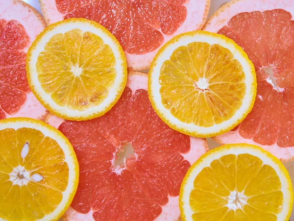 Pomerančový a grapefruitový kroužky pozadí — Stock fotografie
