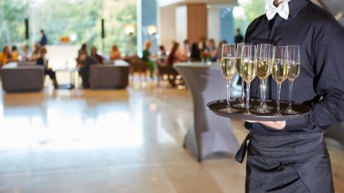 Waiter serving champagne on a tray clipart