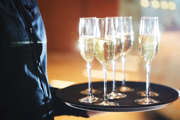 Waiter serving champagne on a tray — Stock Photo, Image