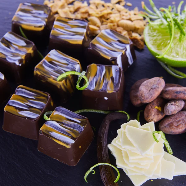 Organic sweet from dark chocolate, lime, almonds — Stock Photo, Image