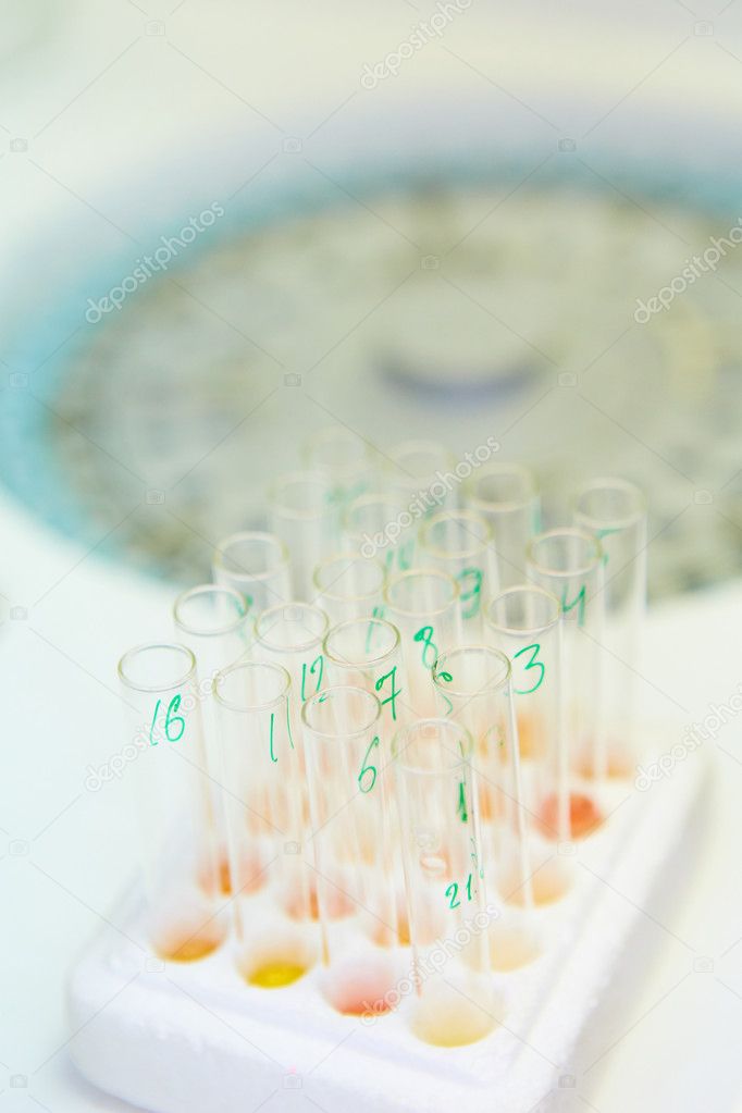 pipette dropping sample into a test tube,abstract science background