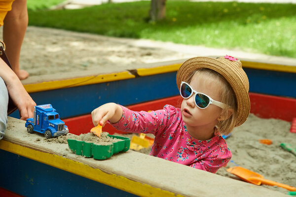 Child on playground in summer park