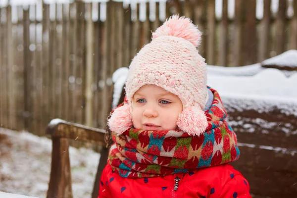 Vinter utomhus porträtt av bedårande drömmande liten flicka i stickad hatt och halsduk. — Stockfoto