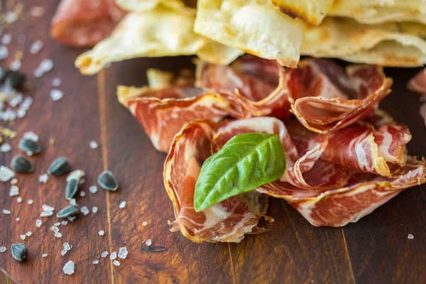 Prosciutto ham and grissini bread sticks. italian antipasto. Shallow dof. — Stock Photo, Image