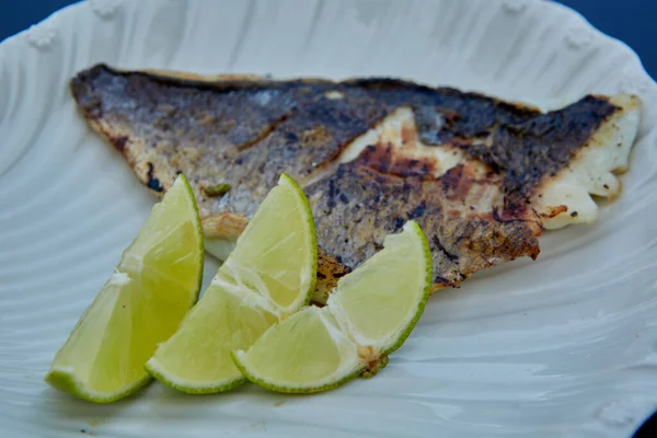 De witte vis op bord met limoen. Koosjer eten. Ondiepe dof. — Stockfoto