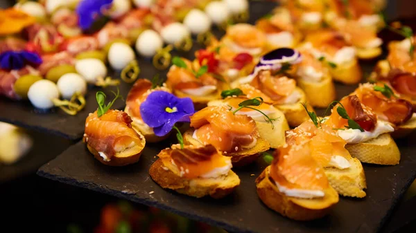 Delicious canapes with smoked salmon. Shallow dof. — Stock Photo, Image