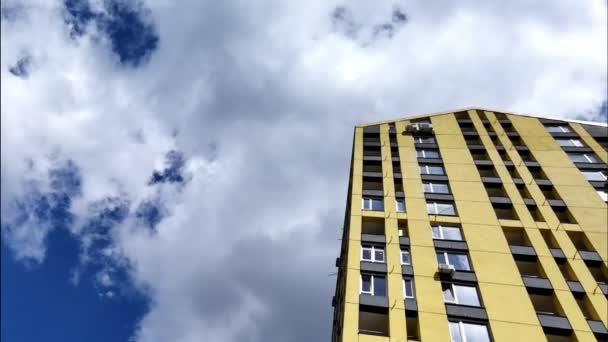 Κίτρινο φωτεινό σπίτι ενάντια στον γαλάζιο ουρανό — Αρχείο Βίντεο