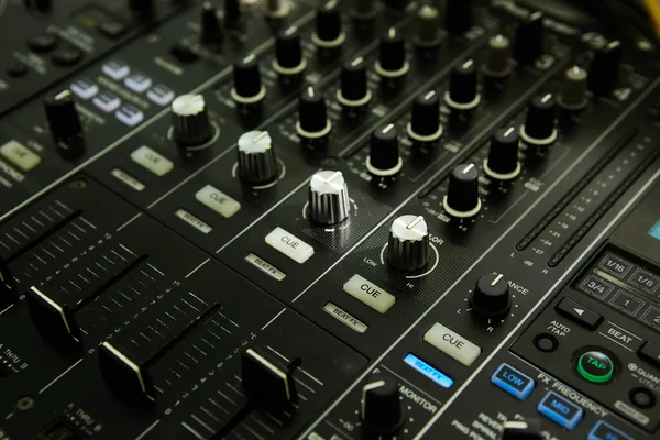 Wide angle photo of black sound mixer controller with knobs and sliders — Stock Photo, Image