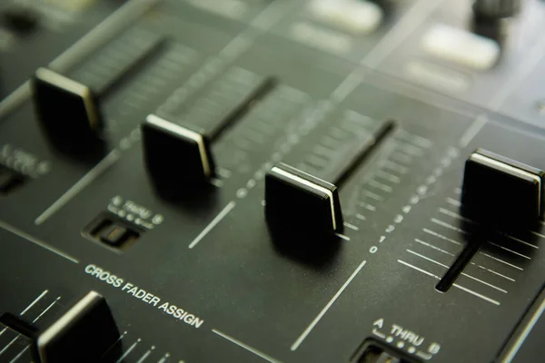 Wide angle photo of black sound mixer controller with knobs and sliders — Stock Photo, Image