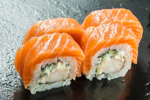 Salmon and caviar rolls served on a plate — Stock Photo, Image