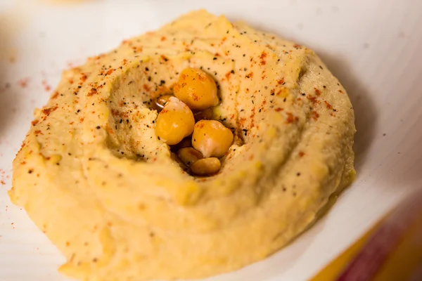 Bowl of creamy hummus — Stock Photo, Image