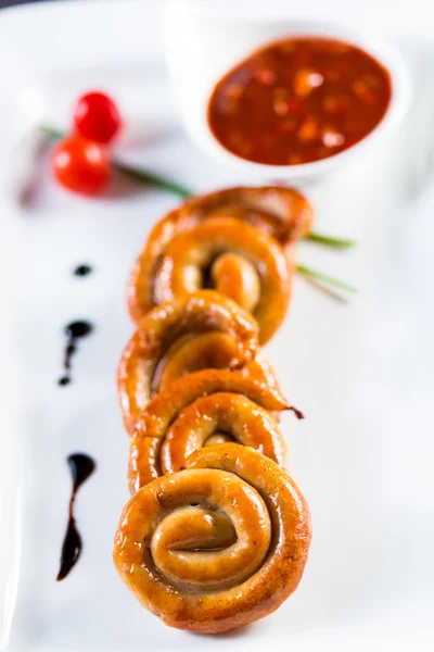 Organic grilled sausages on a white plate. — Stock Photo, Image