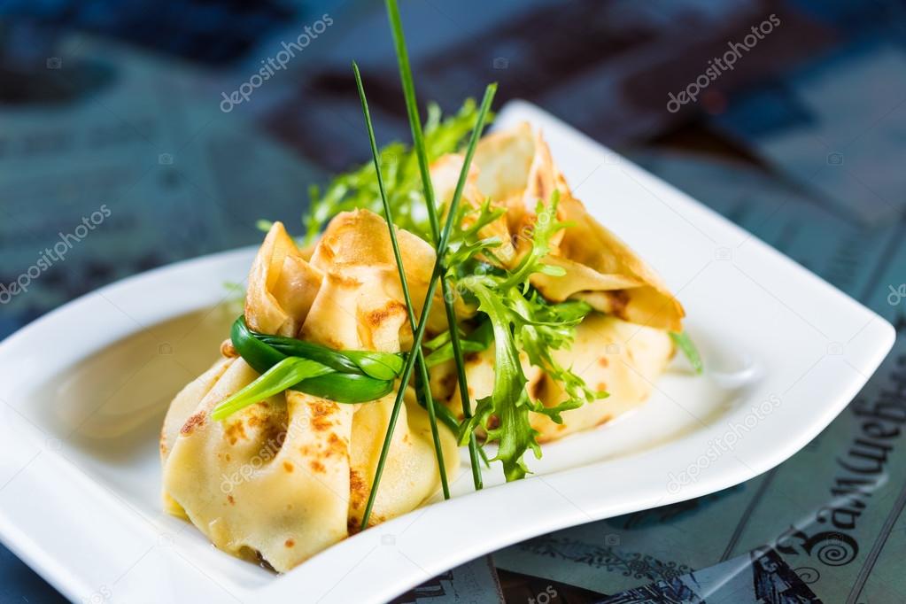 pancakes with meat decorated green onions