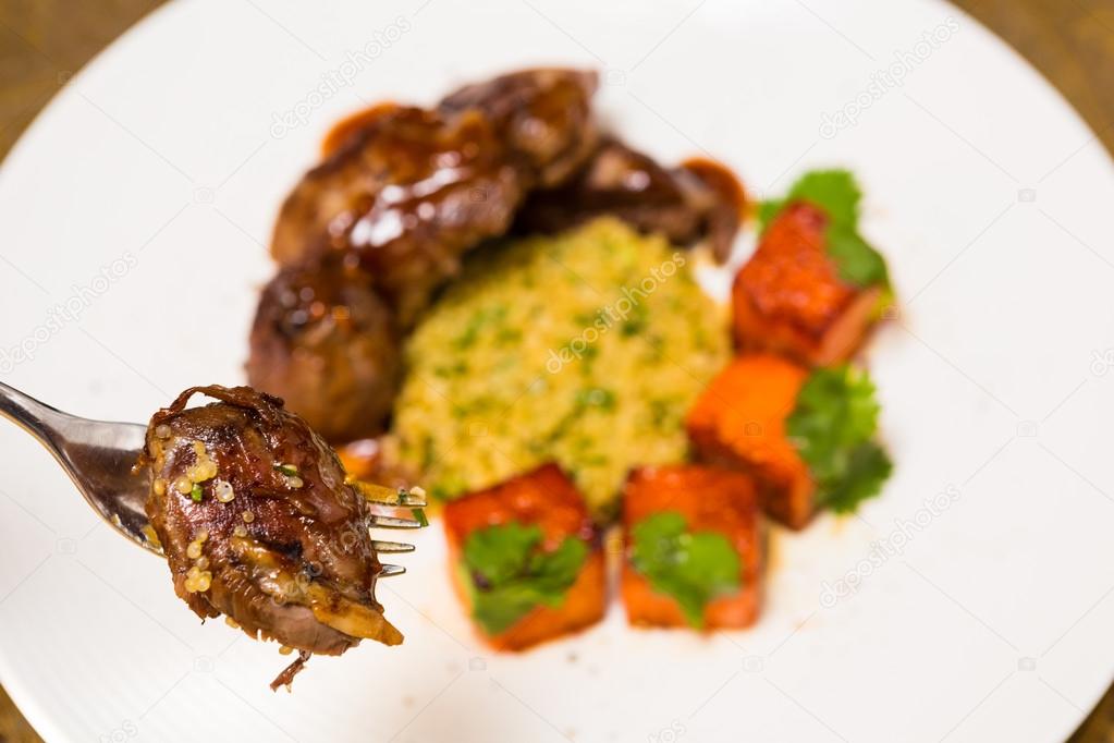 Organic meat of lamb cooked with slices pumpkin and quinoa in oriental style