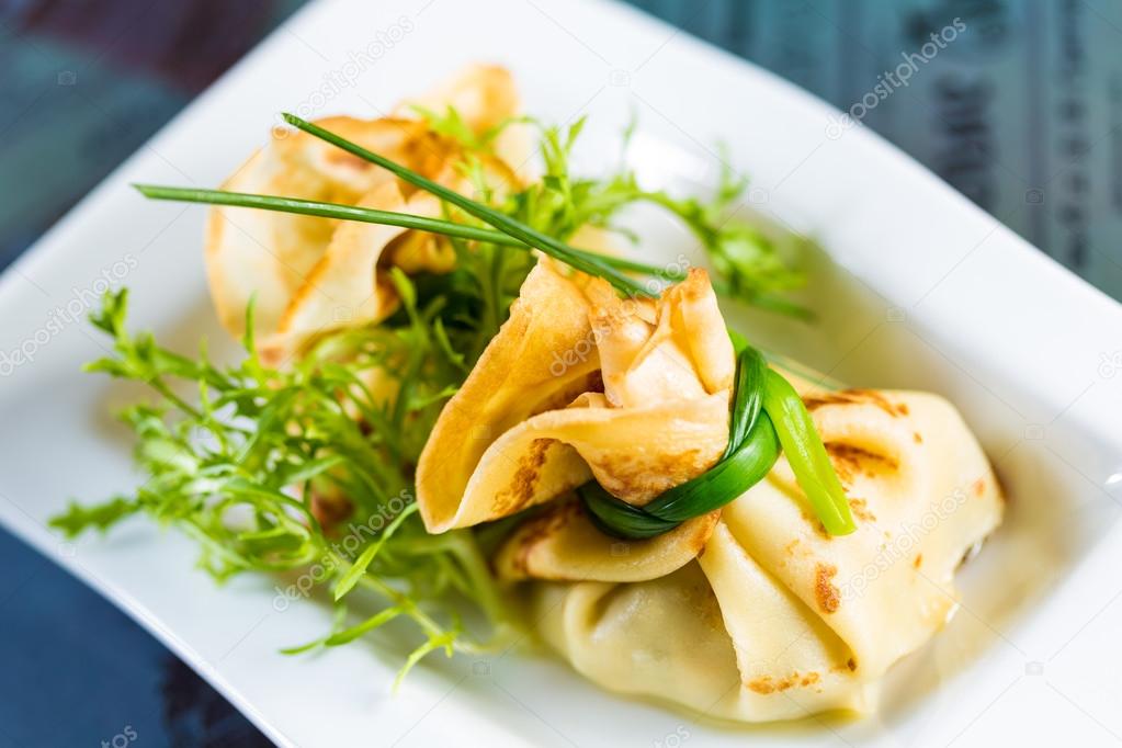 pancakes with meat decorated green onions