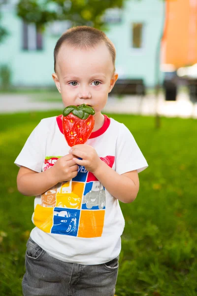 Young boy with colorful lollipop — Stock Photo, Image