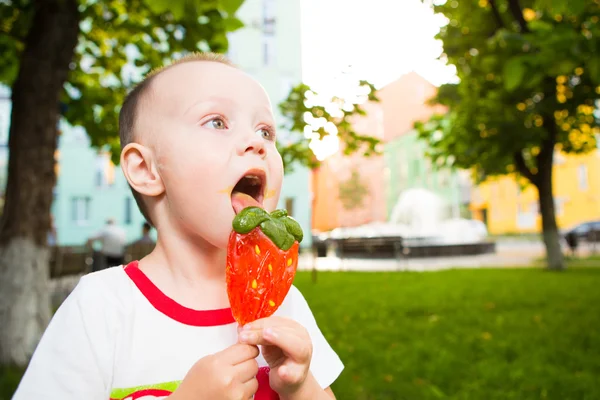 Young boy with colorful lollipop — Stock Photo, Image