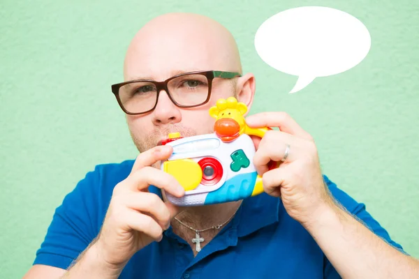 Young man taking photo with toy camera — Stock Photo, Image