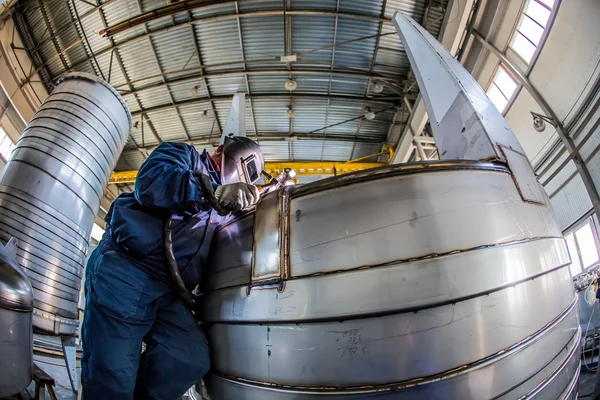 Man welding with reflection of sparks on visor. Hard job. — Stock Photo, Image