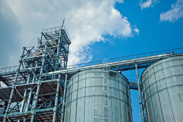 Towers of grain drying enterprise at sunny day