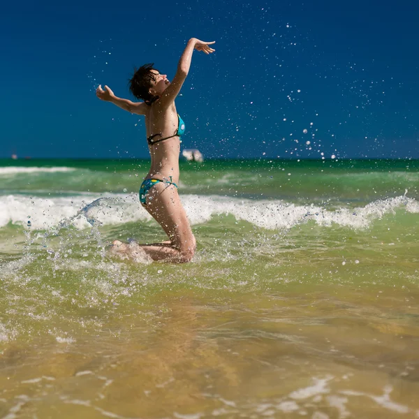 Mulher espirrando água no oceano — Fotografia de Stock