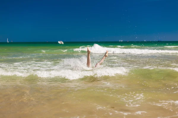 Woman splashing water in the ocean — Stock Photo, Image