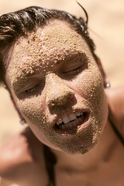 Beautiful girl with sand on face — Stock Photo, Image