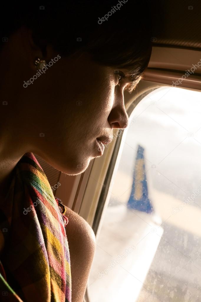 female airplane passanger enjoying the view