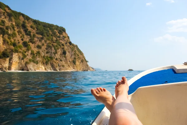 Woman lounging on a catamaran sailboat — Stock Photo, Image