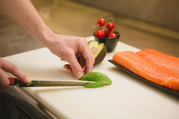 Cutting the salmon with a knife — Stock Photo, Image