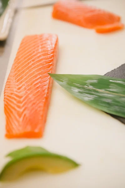 Cutting the salmon with a knife — Stock Photo, Image