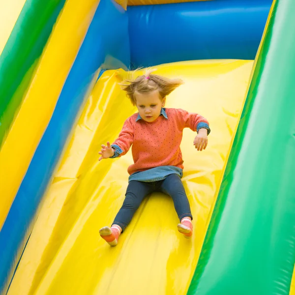 Little girl playing on a trampoline. — Stock Photo, Image