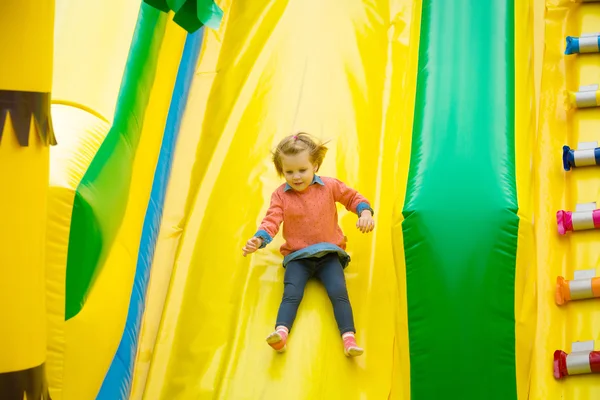 Little girl playing on a trampoline. — Stock Photo, Image