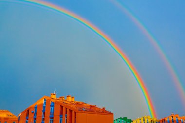 Double rainbow over the city clipart