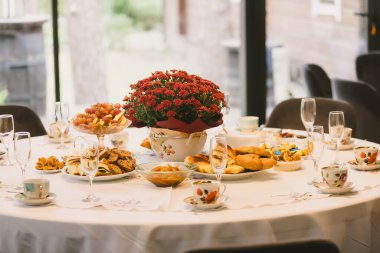 A beautiful table set for an autumn celebration. A concept for family gatherings, togetherness, and the cozy hygge lifestyle
