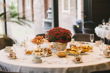 A beautiful table set for an autumn celebration. A concept for family gatherings, togetherness, and the cozy hygge lifestyle