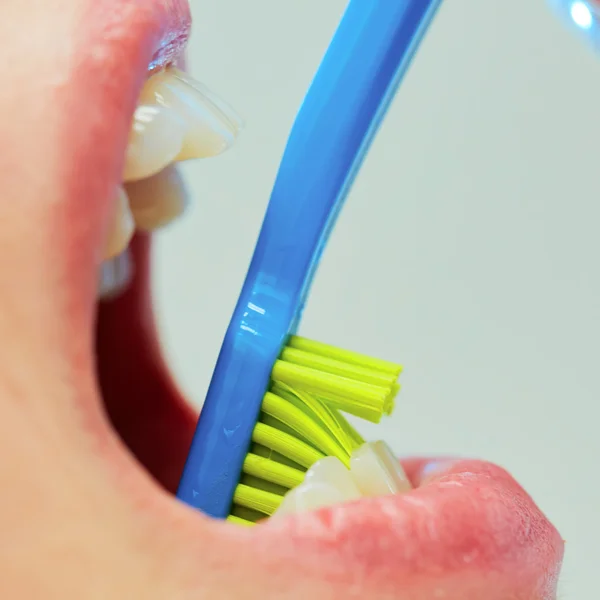 Dentist showing a woman how to brush her teeth — Stock Photo, Image