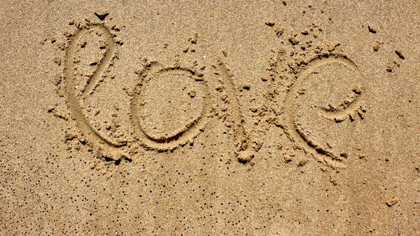 Love message written in sand — Stock Photo, Image