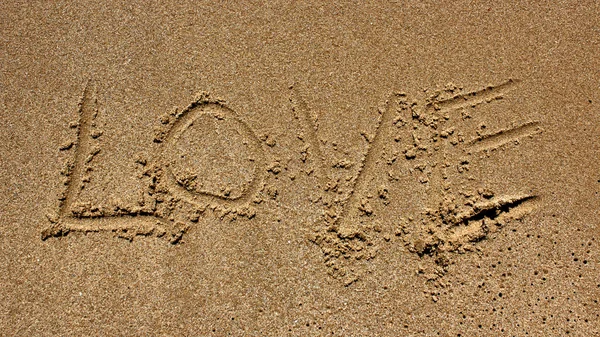 Love message written in sand — Stock Photo, Image