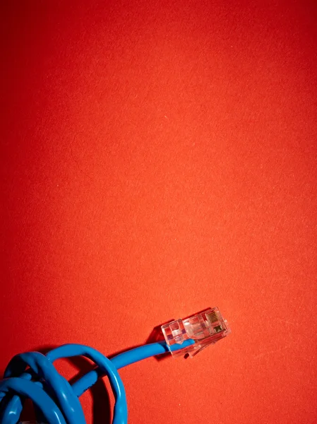 Blue network cable on red background — Stock Photo, Image