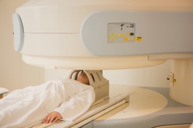 Patient being scanned and diagnosed on a computed tomography clipart