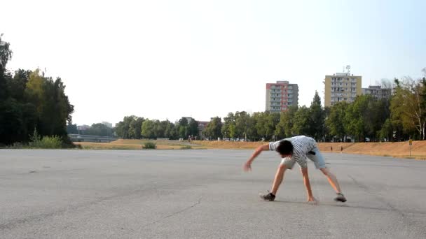 Молодой человек танцует брейк-данс на улице — стоковое видео