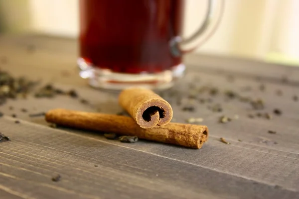 Cup with spices on wooden table — Stock Photo, Image