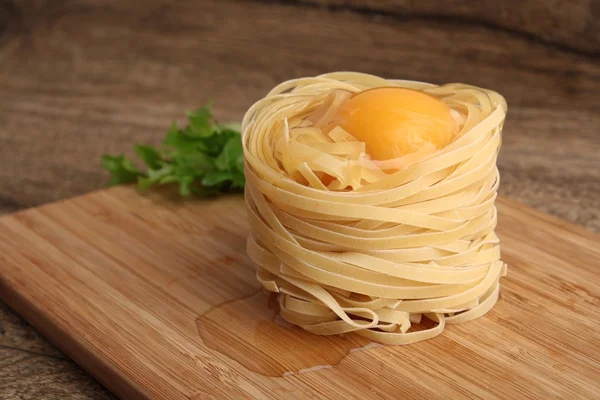 Fettuccini nests with egg — Stock Photo, Image