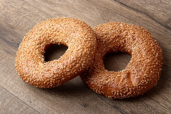 Bagel with sesame seeds and milk — Stock Photo, Image
